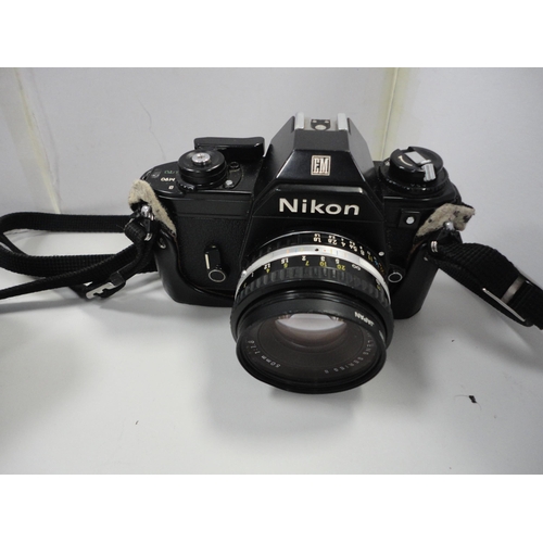 83 - Nikon EM camera with Vivitar lens and accessories, contained in a camera bag.