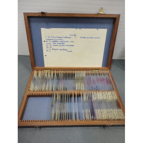 92 - Microscope in fitted box and boxes of various slides.