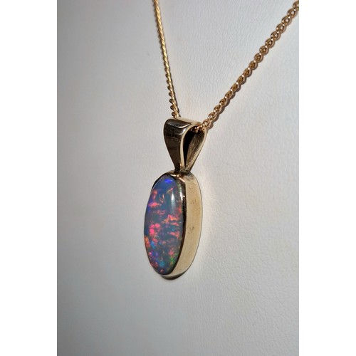 231 - Opal doublet mounted in a yellow metal pendant on 9ct gold chain, gross weight 4.7g