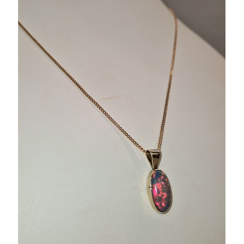 231 - Opal doublet mounted in a yellow metal pendant on 9ct gold chain, gross weight 4.7g