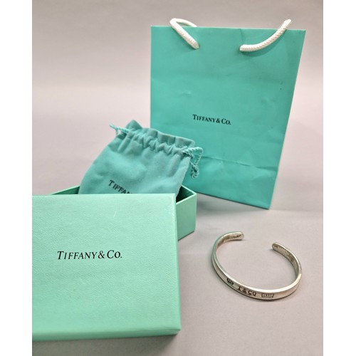 236 - Tiffany & Co silver stiff bangle dated 1999, with pouch, box, and bag