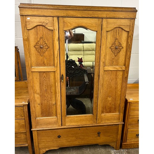 598 - Oak bedroom suite comprising mirrored wardrobe, two over two mirror back chest and three-drawer ches... 