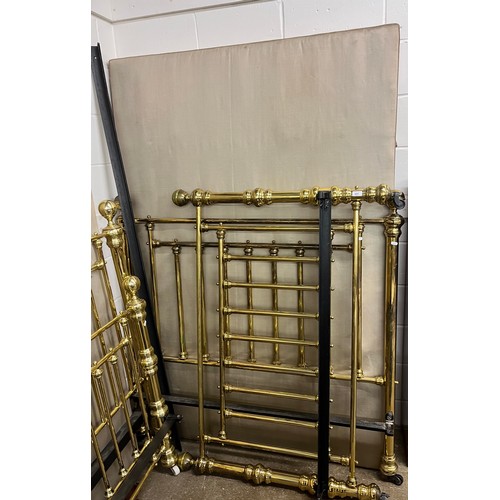 651 - Large brass bedframe on casters, the base board measures 203cm x 135cm