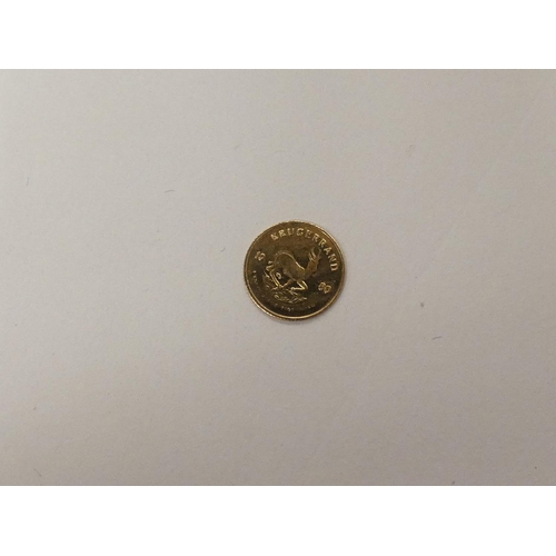 122 - Small 14ct gold 0.3 gram South African coin.