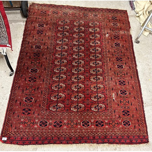 683 - Eastern-style floor rug, possibly Turkmenistani (damaged), 179cm x 142cm