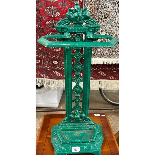 674 - Green painted umbrella stand containing assorted umbrellas