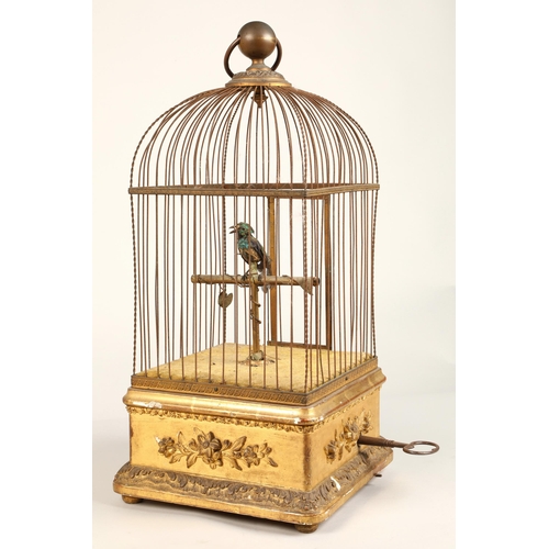 190 - A 19th century mechanical singing bird in a cage, mounted on a gilded base, 55cm high.