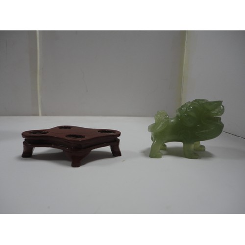 204 - Small Chinese-style jade-coloured censer and cover on stand, and a similar jade-coloured temple dog.... 