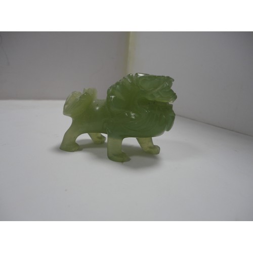 204 - Small Chinese-style jade-coloured censer and cover on stand, and a similar jade-coloured temple dog.... 