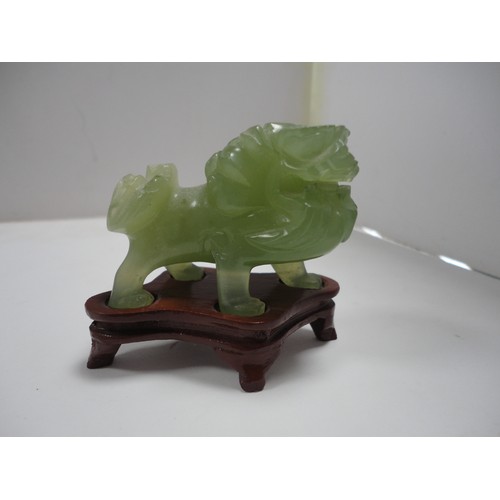 204 - Small Chinese-style jade-coloured censer and cover on stand, and a similar jade-coloured temple dog.... 