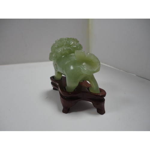 204 - Small Chinese-style jade-coloured censer and cover on stand, and a similar jade-coloured temple dog.... 