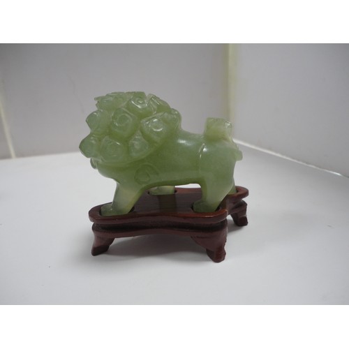 204 - Small Chinese-style jade-coloured censer and cover on stand, and a similar jade-coloured temple dog.... 