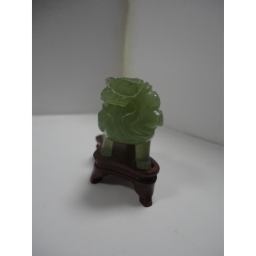 204 - Small Chinese-style jade-coloured censer and cover on stand, and a similar jade-coloured temple dog.... 