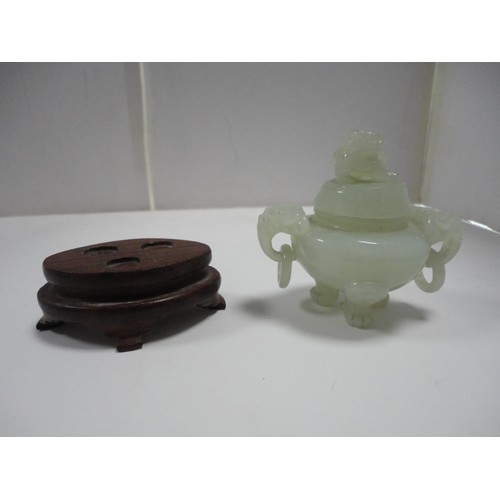 204 - Small Chinese-style jade-coloured censer and cover on stand, and a similar jade-coloured temple dog.... 