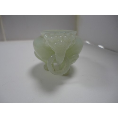 204 - Small Chinese-style jade-coloured censer and cover on stand, and a similar jade-coloured temple dog.... 