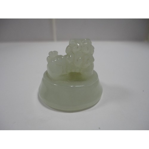 204 - Small Chinese-style jade-coloured censer and cover on stand, and a similar jade-coloured temple dog.... 