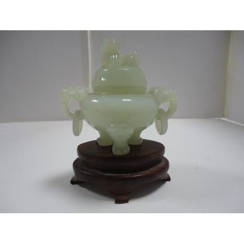 204 - Small Chinese-style jade-coloured censer and cover on stand, and a similar jade-coloured temple dog.... 