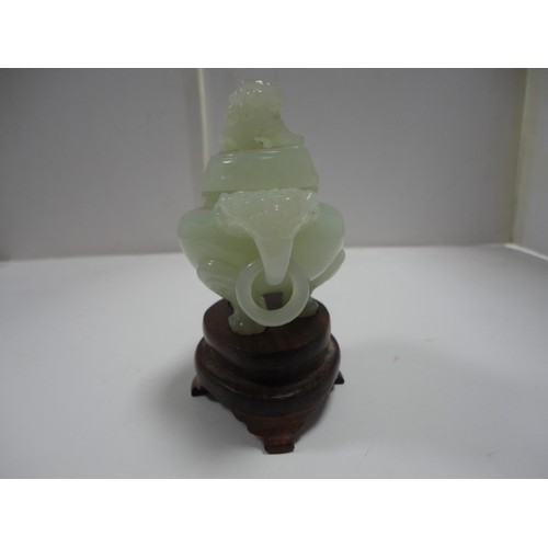 204 - Small Chinese-style jade-coloured censer and cover on stand, and a similar jade-coloured temple dog.... 