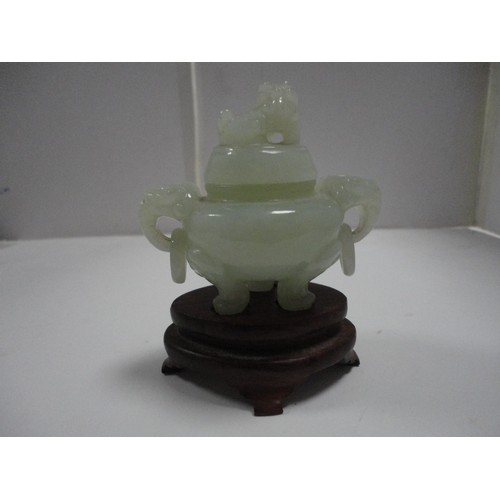 204 - Small Chinese-style jade-coloured censer and cover on stand, and a similar jade-coloured temple dog.... 