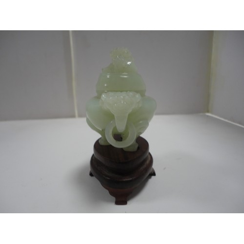 204 - Small Chinese-style jade-coloured censer and cover on stand, and a similar jade-coloured temple dog.... 