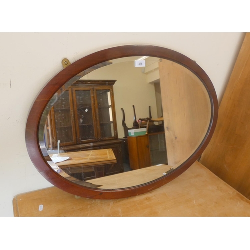 62 - Large oval mahogany wall mirror.