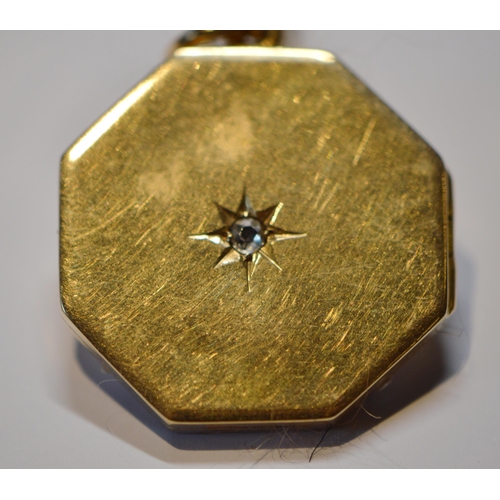 152 - 18ct gold octagonal locket with diamond, 1916, 8.9g. (excluding metal necklet).