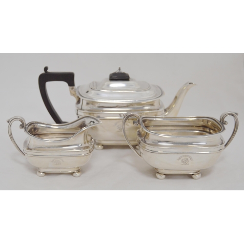 116 - Silver three-piece tea service in the Georgian taste comprising a teapot, sugar and cream, crested t... 