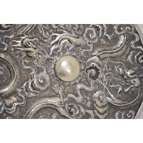 121 - Chinese silver export hand mirror with ring handle (late Qing dynasty), decorated with embossed drag... 