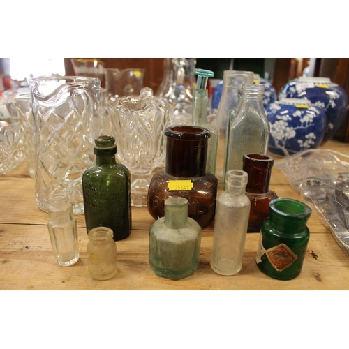 157 - Glassware to include crystal bowls, ewer jugs, etc., and vintage bottles to include Bovril, Gordons ... 