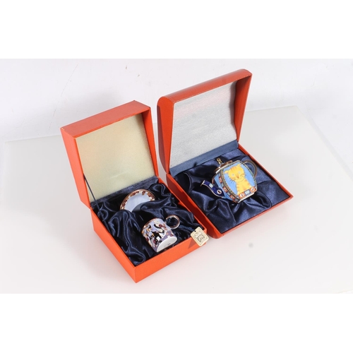 160 - Two Charlotte de Vita hand painted enamelled boxed items to include a cat decorated miniature teapot... 