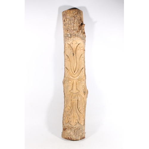 26 - Folk Art carved tree trunk panel depicting a face of the Green Man, 96cm high.