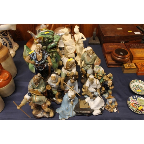 35 - Chinese pottery foo dog, oriental 'Mud Men' pottery models of fishermen, etc., a paperweight, a trin... 