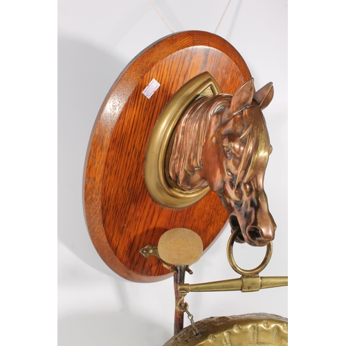 49A - Brass and copper dinner gong hanging from a horsehead bust on oak frame.