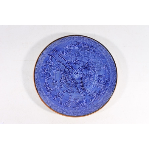 55 - Chinese pottery charger dish decorated with prunus blossom, 33cm diameter.