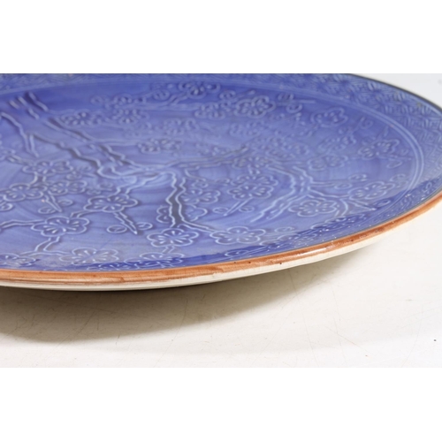 55 - Chinese pottery charger dish decorated with prunus blossom, 33cm diameter.