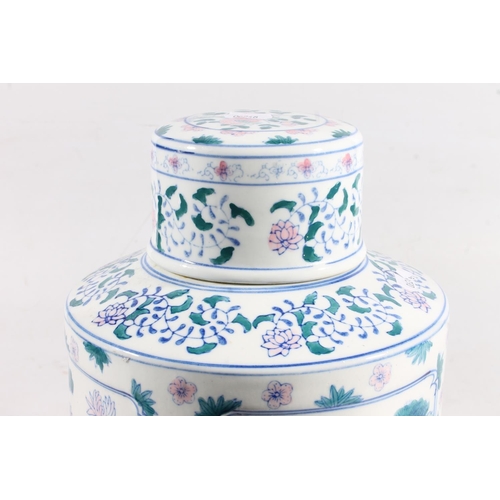 59 - Reproduction Chinese blue, white, green and pink decorated jar and cover, 31cm high.