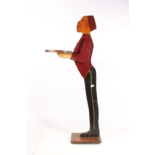 7 - Carved and painted Bell Boy wood dumb waiter, 84cm high.