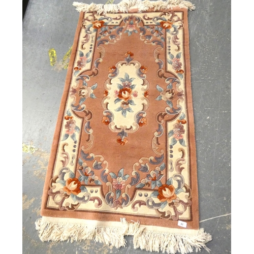 82 - Small, modern, pink Chinese rug.