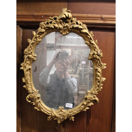 772 - Rococo style gilt framed wall mirror, 62cm high.