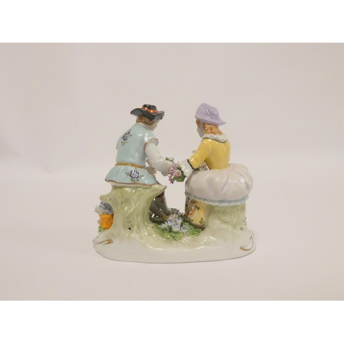 164 - Sitzendorf figure of a rustic couple in 18th century dress, making flower sprays, 15cm wide.