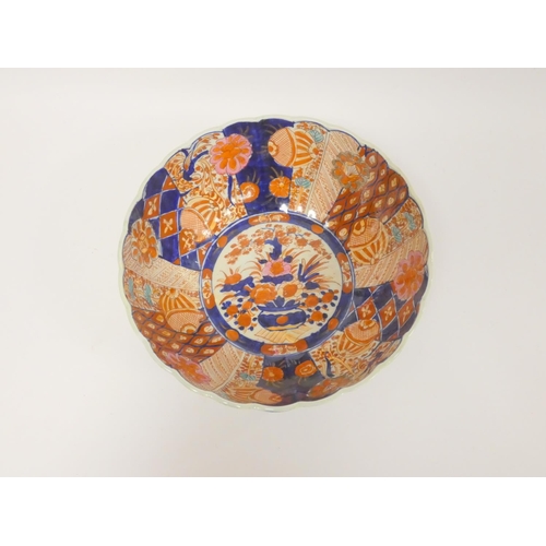 217 - 19th century Imari bowl of lobed form decorated in typical palette with urn of flowers and branches ... 