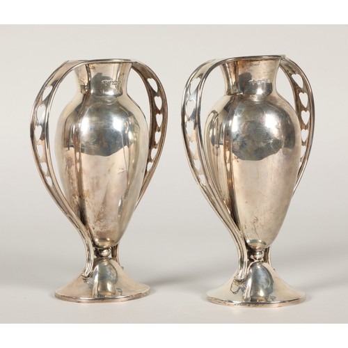 157 - Pair of silver handled vases, footed baluster form with each handle having pieced heart decoration, ... 