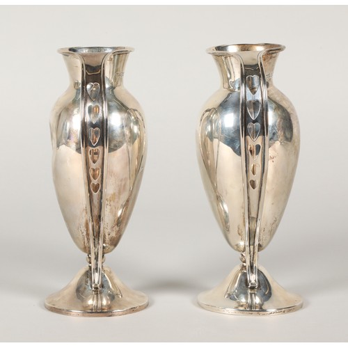 157 - Pair of silver handled vases, footed baluster form with each handle having pieced heart decoration, ... 