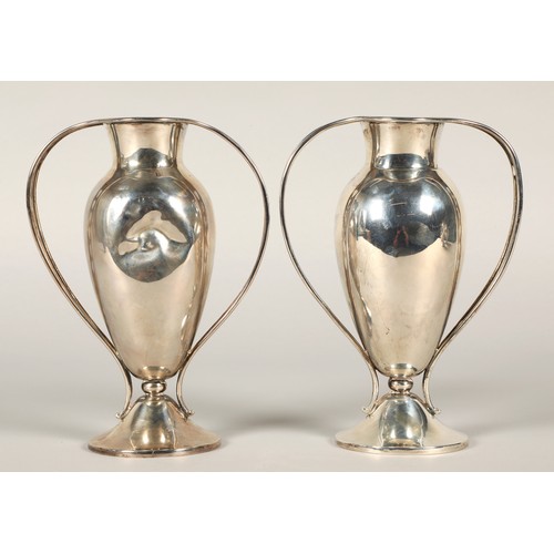 157 - Pair of silver handled vases, footed baluster form with each handle having pieced heart decoration, ... 