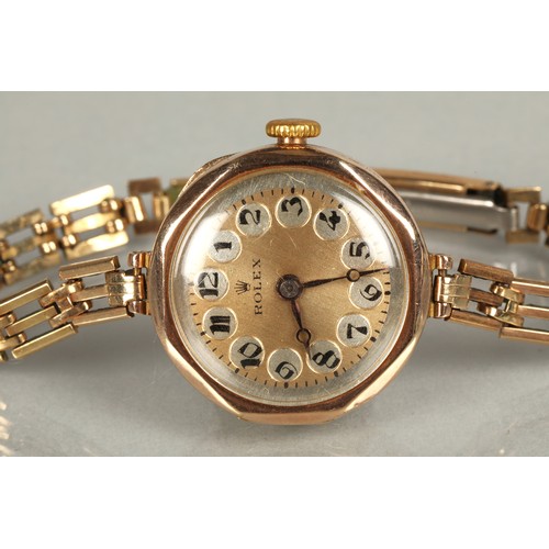 112 - Rolex ladies vintage 9ct gold wrist watch on a rolled gold and stainless steel strap.