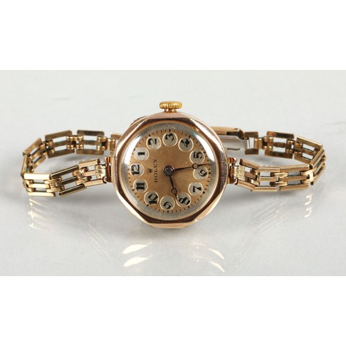 112 - Rolex ladies vintage 9ct gold wrist watch on a rolled gold and stainless steel strap.