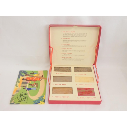 394 - A 1950s Nestle chocolate display case, outlining the various stages of chocolate production, along w... 