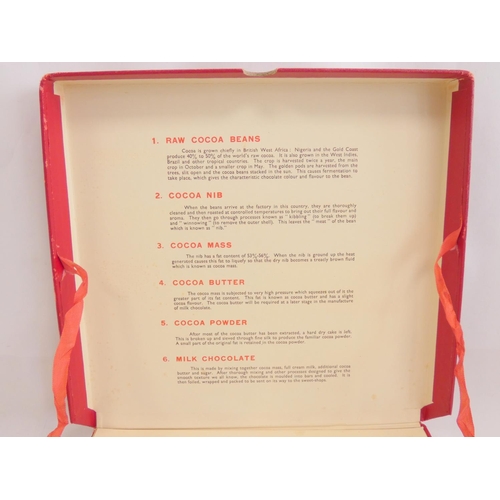 394 - A 1950s Nestle chocolate display case, outlining the various stages of chocolate production, along w... 