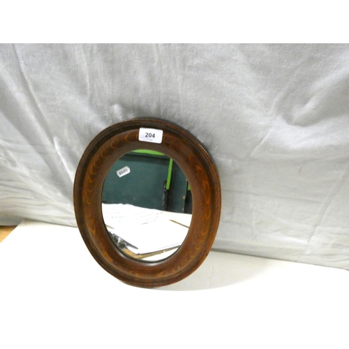 204 - Small, oval framed wall mirror.