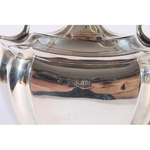 13 - George V silver spirit kettle, of typical shape, the turned wooden handle and finial over a shaped b... 